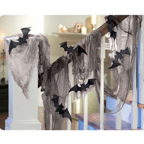 Halloween Gauze Decorating Kit features glittery black paper bats and black gauze| this kit makes a great Halloween decoration for fireplace mantels| stairway banisters and more. Just attach with included foam tape and your spooky scene is complete. Includes: Gauze| 61cm x 4.57m| 8 Bats and 25cm Foam tape.