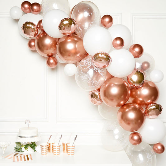 Rose Gold DIY Garland Balloon Kit includes 15 x 5 inch Satin Luxe Rose Gold Balloons, 15 x 5 inch White Balloons, 10 x 11 inch Satin Luxe Rose Gold Balloons, 10 x 11 inch White Balloons, 8 x 11 inch Clear Confetti Filled Balloons, 2 x 14 inch Rose Gold Balloons, 6 x 9 inch Rose Gold Foil Balloons, Sticky Dots and Balloon Tape.
