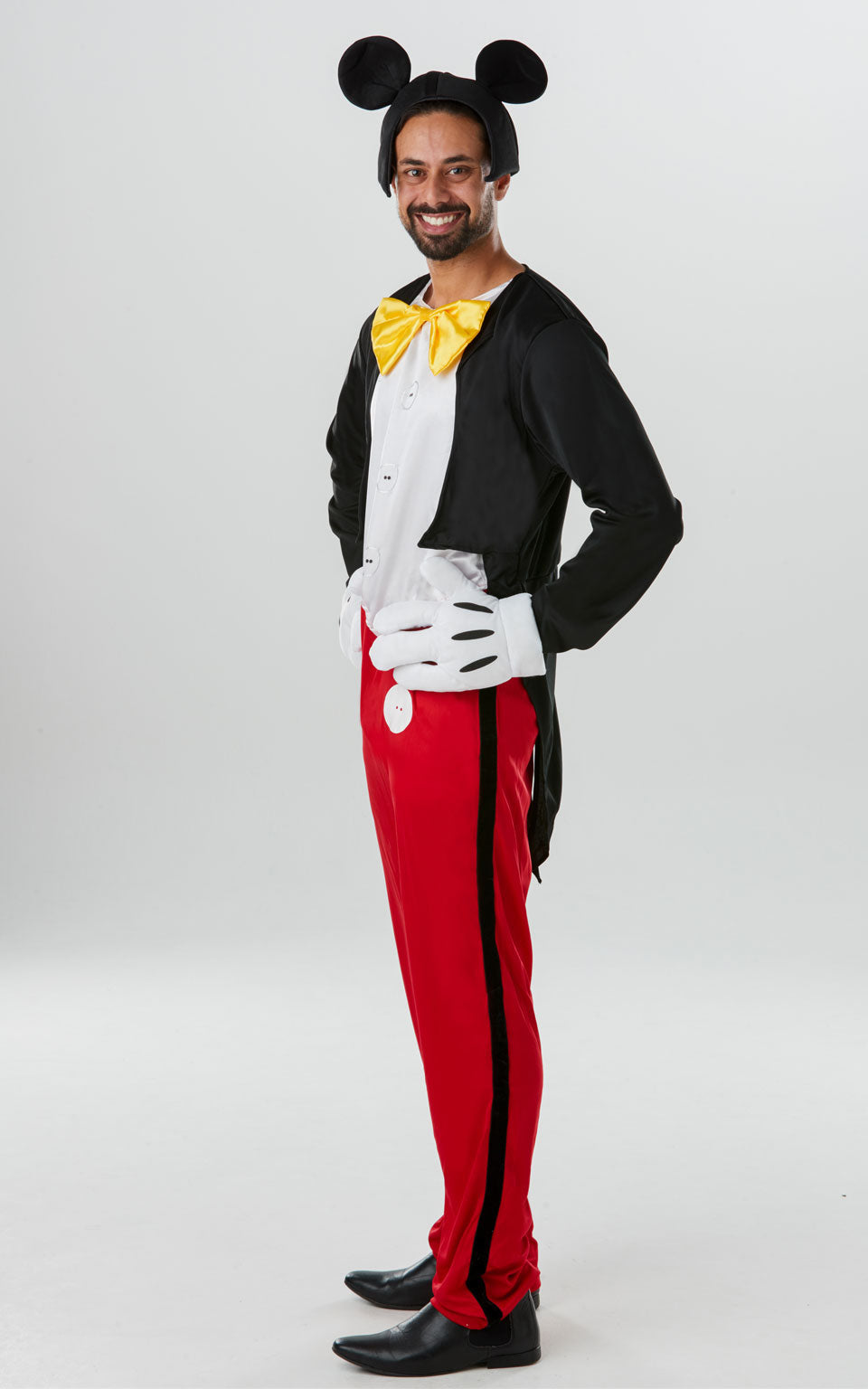 Disney Mickey Mouse Costume includes all in one jumpsuit with digitally printed buttons, black stripes down the legs, sewn in vest and attached mock jacket. Jumpsuit features attached satin bow tie. Velcro closures at rear. Oversized fibre filled gloves with printed details and four fibre filled fingers. Headpiece is a foam backed fabric snood with attached iconic Mickey Mouse ears. This is an officially licensed Disney product.
